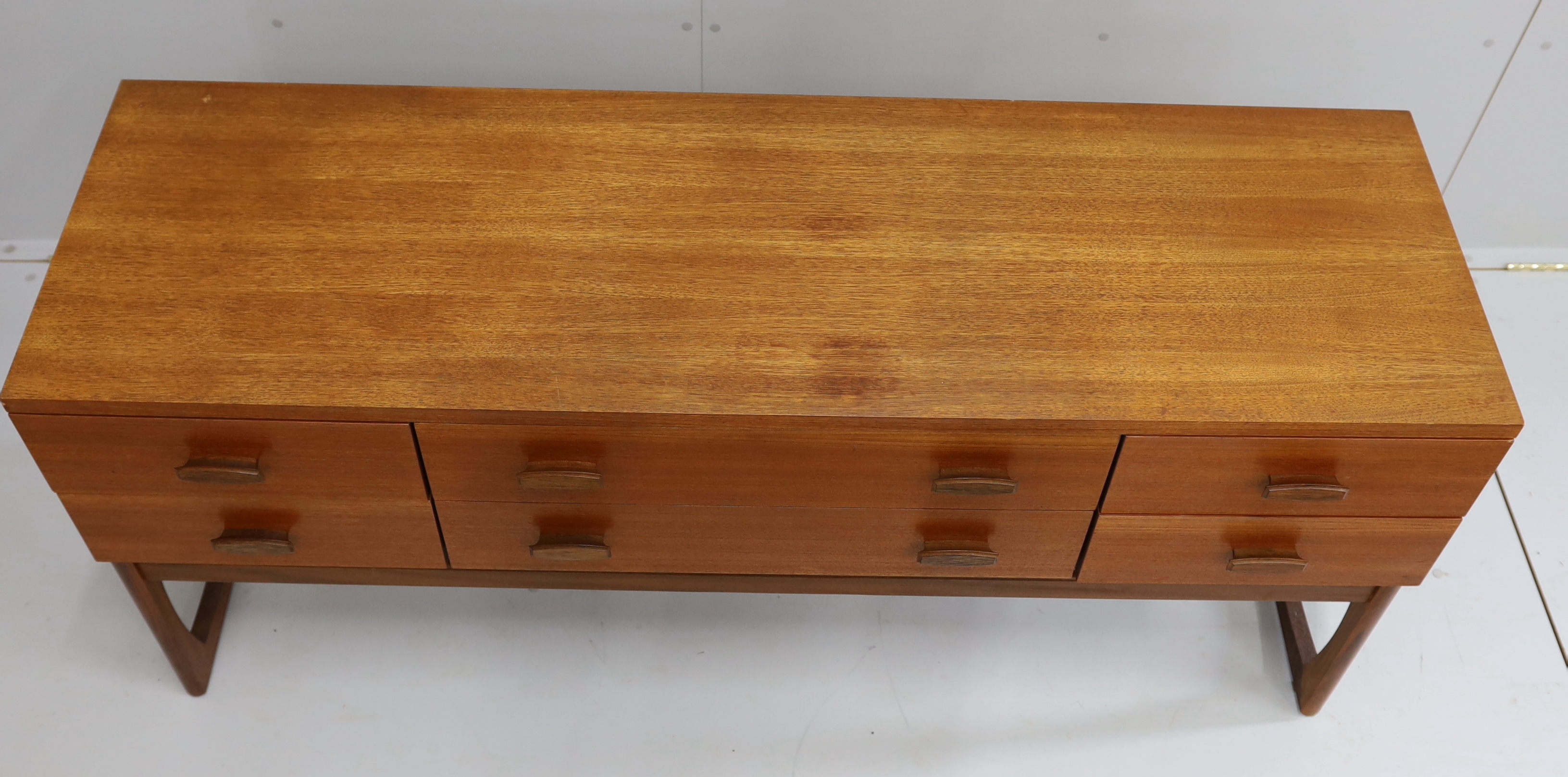 Ib Kofod Larsen for G Plan, a teak six drawer dressing table, length 152cm, depth 46cm, height 71cm (mirror back present but in need of repair)